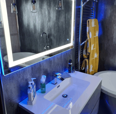 DIY bathroom wall panel transformation with Charcoal Carrara Marble panels and chrome trims